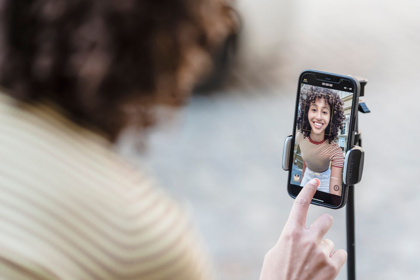 A creator recording a social video with a smartphone